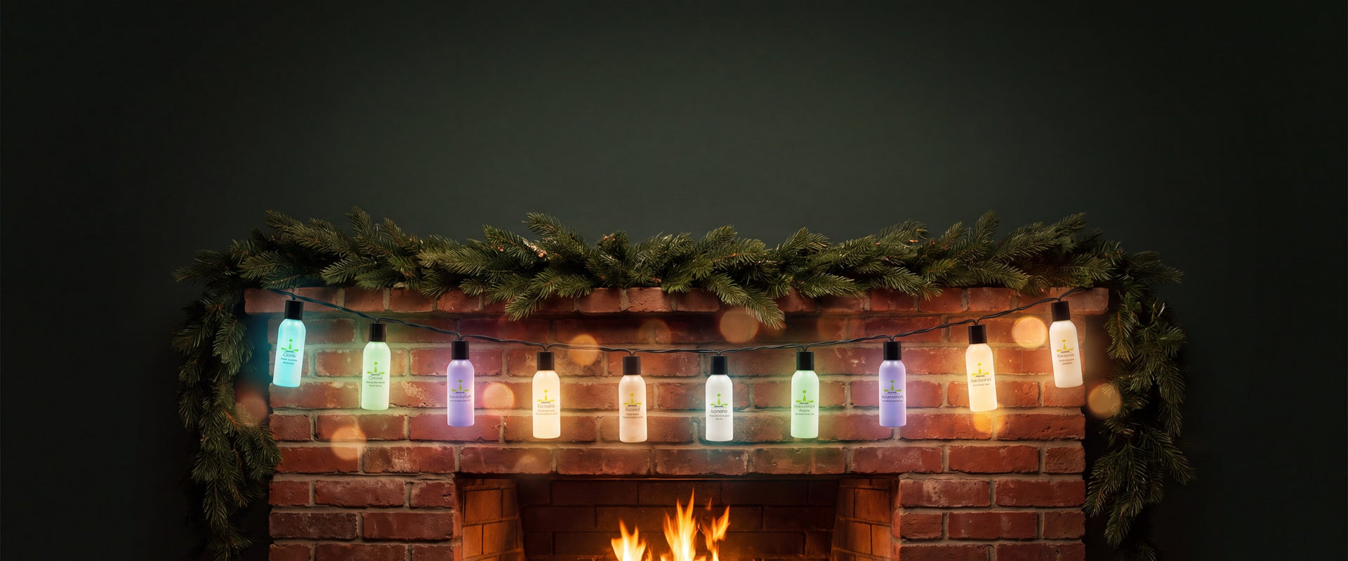 Mantra 2 oz favor bottles glowing like Christmas lights on a garland over a brick fireplace